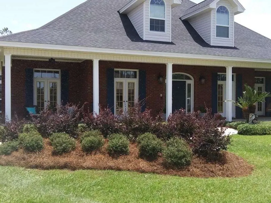 Brick home with new shrub beds