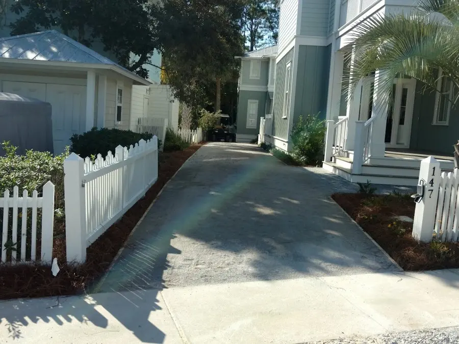 Walkway and white picket fence with fresh plantings